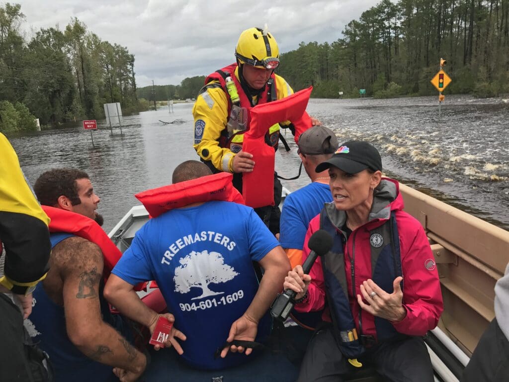 A group of people in a boat on water.